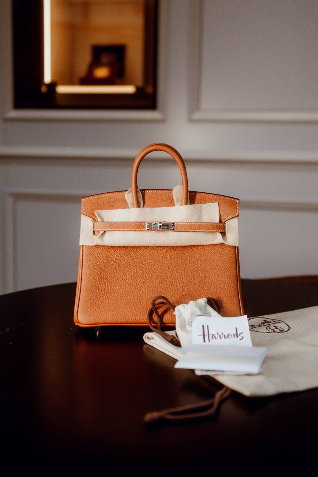 Hermès Birkin 25 wrapped in tissue beside its dust bag and paperwork