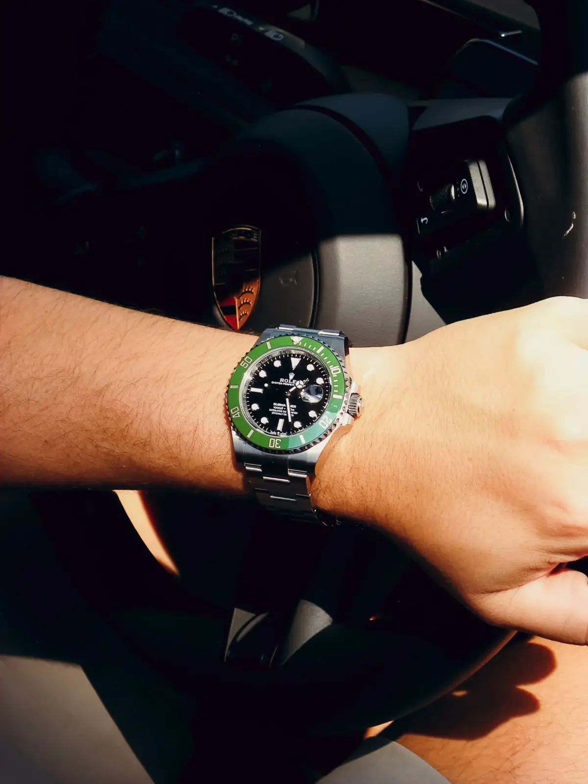 Rolex Submariner 'Starbucks' worn at the wheel of a Porsche