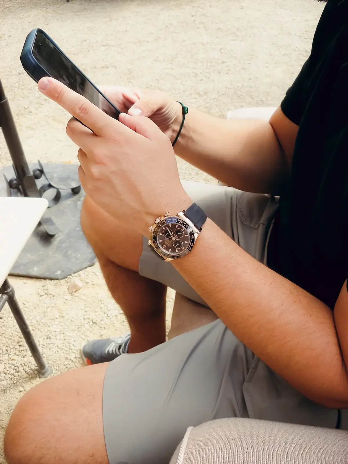 Rolex Daytona in Everose gold worn at a terrace table