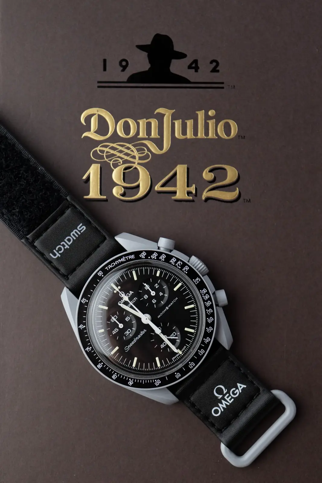 MoonSwatch chronograph photographed on a Don Julio 1942 presentation box