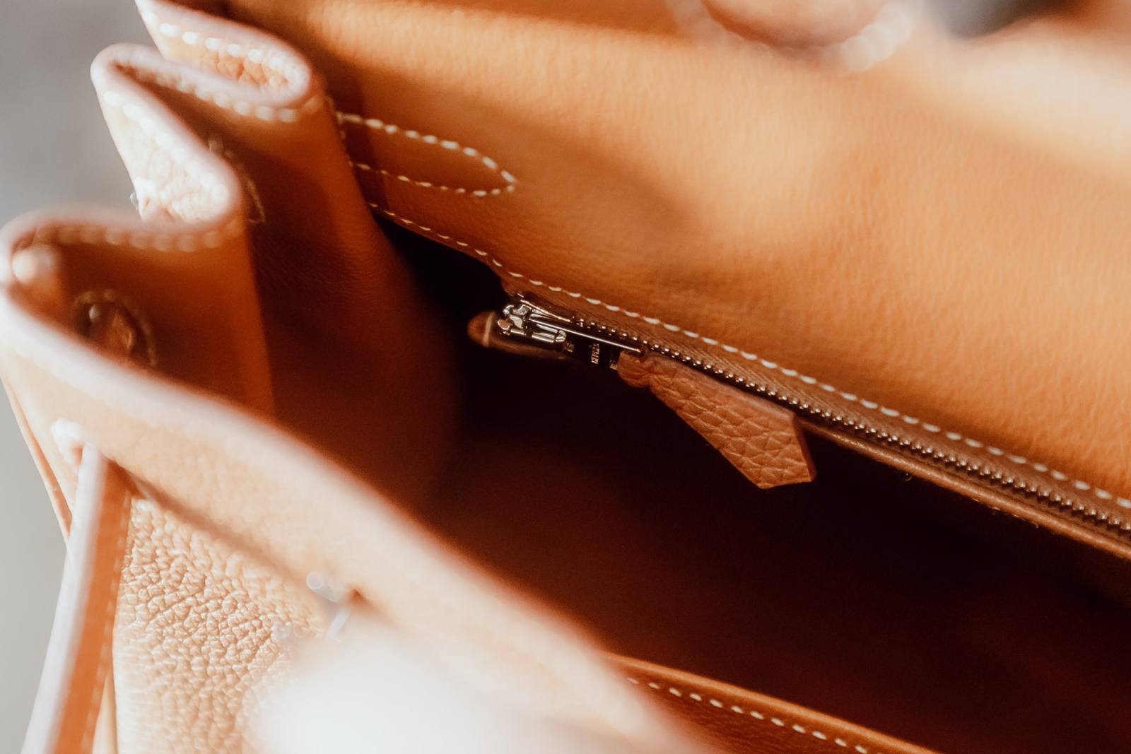 Macro of the interior lining and zip pull of an Hermès Birkin