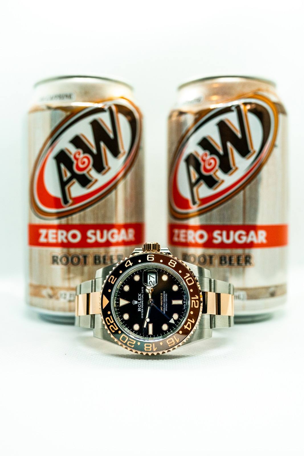 Rolex GMT-Master II Root Beer in Everose and steel in front of root beer cans